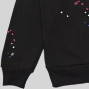 Close-up view of the black Sp5der CB Punk V2 Hoodie featuring unique owl and star graphic print design details.