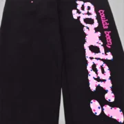 Close up of the black Sp5der CB Punk V2 sweatpants featuring the iconic pink and multicolored owl graphic print.