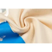 Close-up view of the premium cream fabric texture and branding detail on the Sp5der Cropped Hoodie in a studio setting.