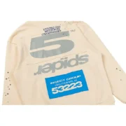 Close-up view of the Sp5der Cropped Hoodie in cream featuring a distressed graphic print and blue brand patch detail.