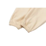 Close-up view of the Sp5der Cropped Sweatpant in cream, showcasing the elasticated ankle hem and premium fabric texture.