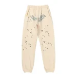 Front view of the Sp5der Cropped Sweatpant in cream color featuring a star-patterned streetwear design.