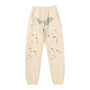 Front view of the Sp5der Cropped Sweatpant in cream color featuring a star-patterned streetwear design.