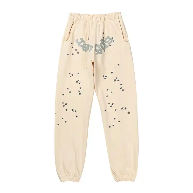 Front view of the Sp5der Cropped Sweatpant in cream color featuring a star-patterned streetwear design.