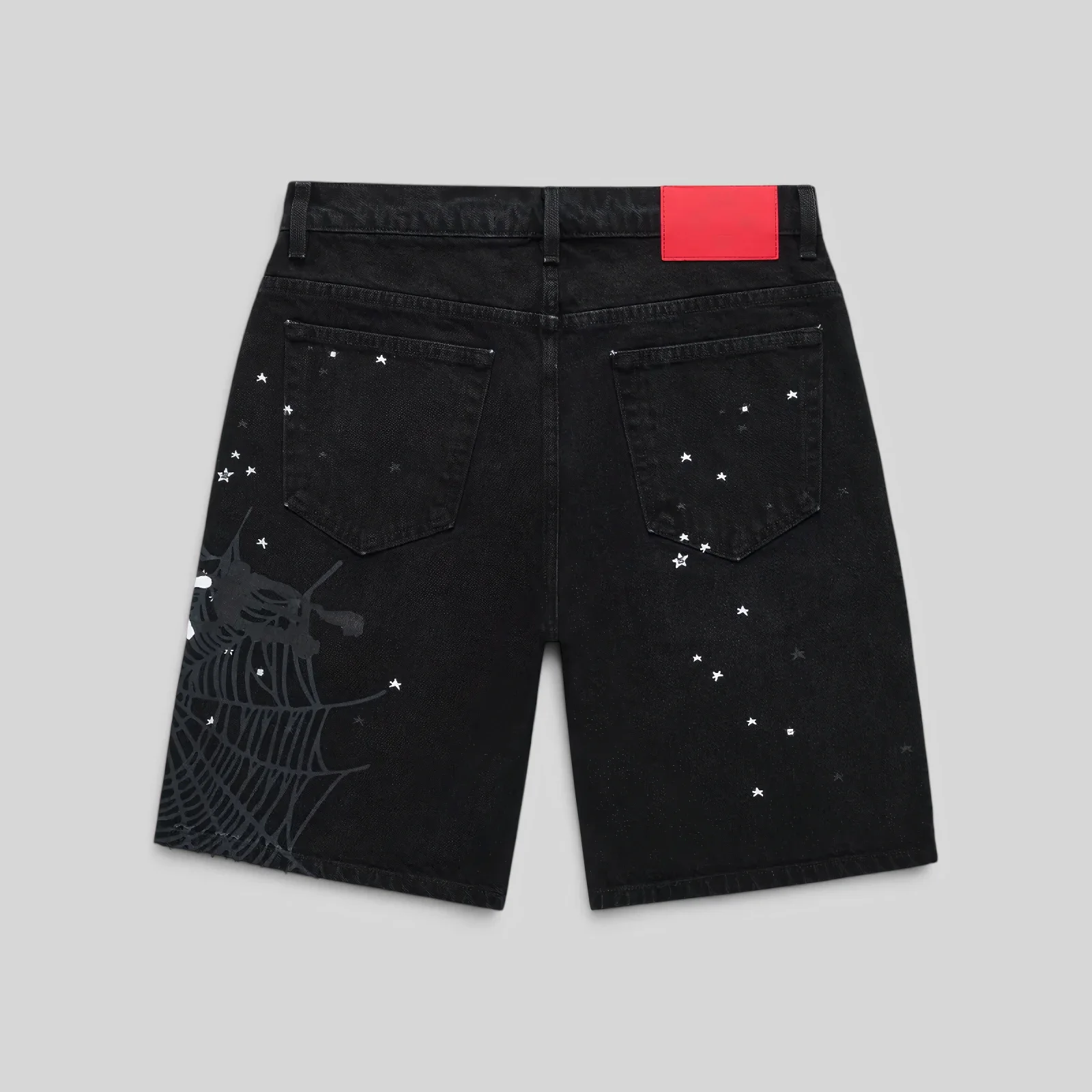 Back view of Sp5der Heavy Web Denim Short in black, featuring a branded leather patch and white web and star prints.