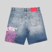 Back view of Sp5der Heavy Web light blue denim shorts featuring a prominent pink spiderweb graphic and star details.