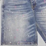 Close-up of Sp5der Heavy Web Denim Shorts in light blue, showing premium construction and streetwear detailing.