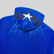Close-up of the Tory Blue Sp5der Heavy Web Full Zip Hoodie showing the signature web graphic print on the back hood.