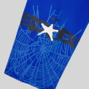 Close-up view of the Sp5der Heavy Web Short in Tory Blue featuring the signature spider web and star graphic print.