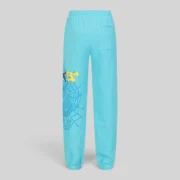 Back view of sky blue Sp5der Heavy Web sweatpants featuring a yellow and blue spider web graphic on the leg.