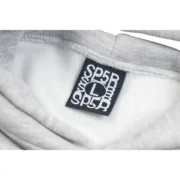 Close-up view of the branded neck label inside the gray Sp5der I Heart SP5 souvenir hoodie featuring size L.