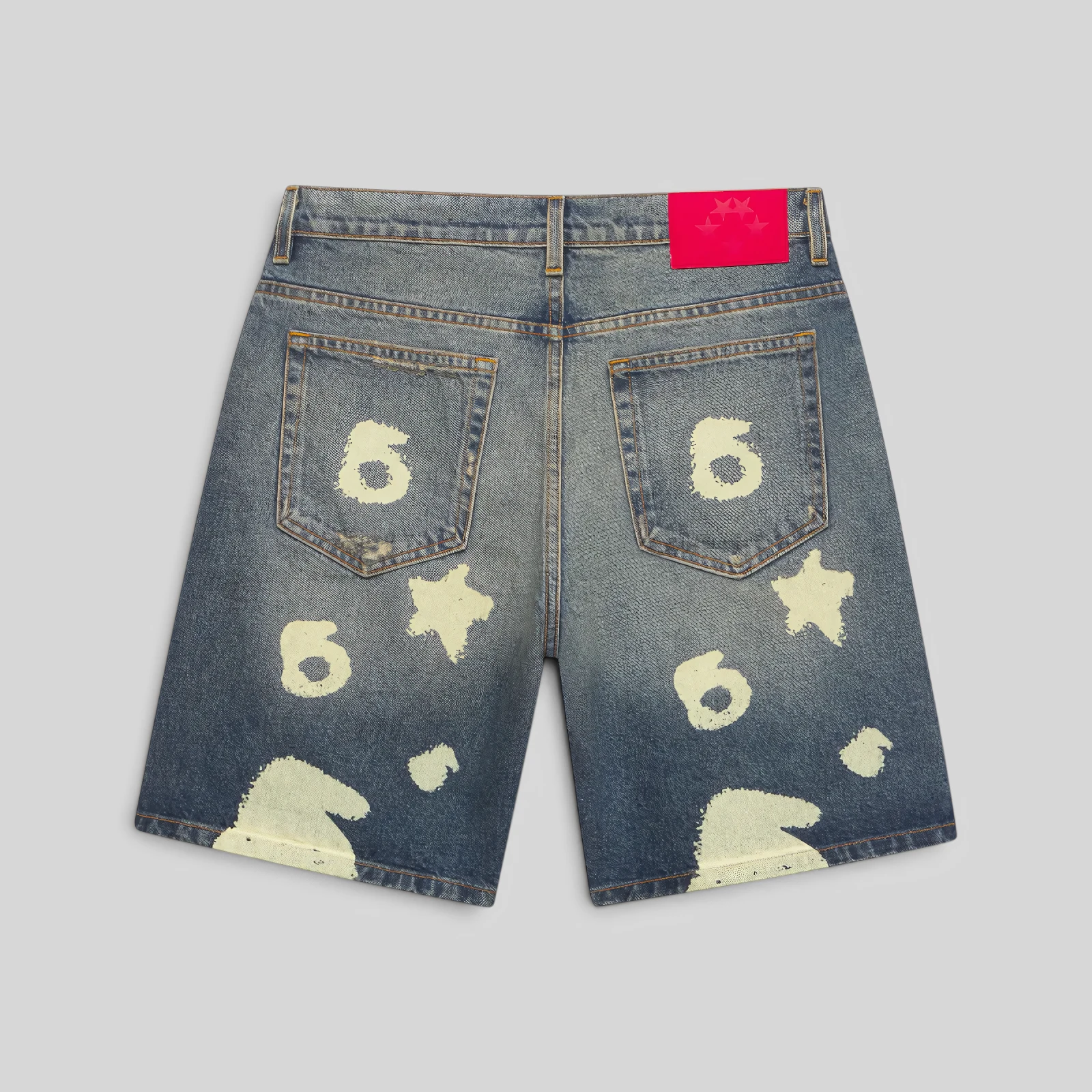 Sp5der Indigo Beluga Denim Short in blue featuring a back view with a signature leather branded patch and graphic print