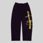 Front view of black Sp5der Issue 404 sweatpants featuring yellow vertical text and white graphic print details.