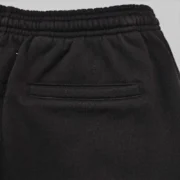 Close-up view of the premium black 13oz cotton fleece fabric and pocket detail on Sp5der Issue 404 sweatpants.