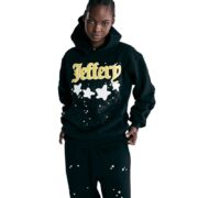 A close-up view of the black Sp5der Jeffery hoodie featuring iconic star branding and text worn by a model in a studio.