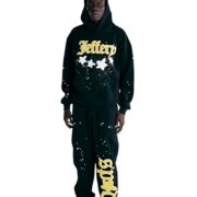 A model wearing the black Sp5der Jeffery hoodie and matching sweatpants set with graphic star and spiderweb designs.