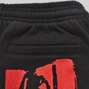 Close-up view of the Sp5der JP5 Moto Sweatpants in black featuring detailed painted motocross-inspired graphic print.