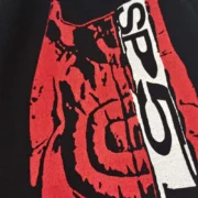 Close-up view of the painted red and white motocross-inspired graphic print on the black Sp5der JP5 Moto Sweatpants.