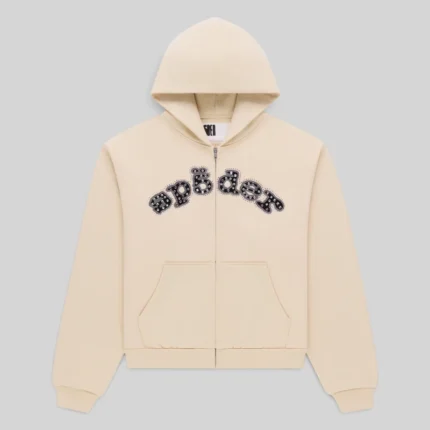Sp5der Mixed Stone OG V2 Zip Hoodie in Cream, featuring premium 13oz cotton fleece and studded logo graphic chest details.