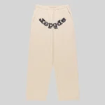 Front view of Sp5der Mixed Stone OG V2 cream sweatpants made from 13oz premium cotton fleece with studded logo detail.