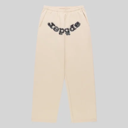 Front view of Sp5der Mixed Stone OG V2 cream sweatpants made from 13oz premium cotton fleece with studded logo detail.