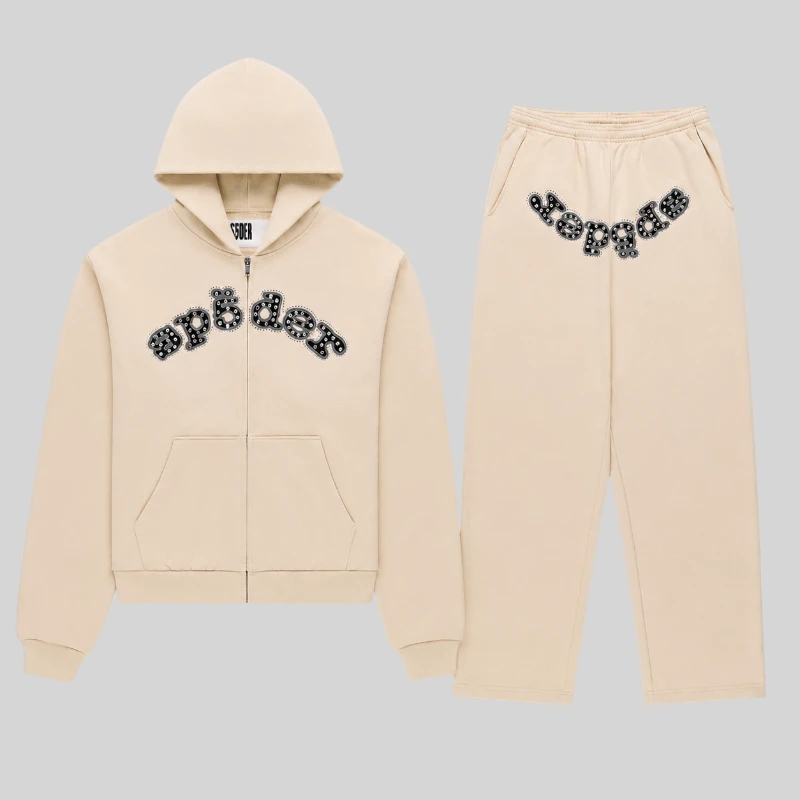 Sp5der Mixed Stone OG V2 Zip Tracksuit in Cream featuring heavy metal stud embellishments on a cotton fleece set.