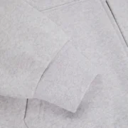 Close-up view of the premium 13oz cotton fleece fabric on the Heather Grey Sp5der Mx555 zip-up hoodie design.