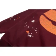 Close-up view of the Sp5der Nocturnal Highway Hoodie in maroon, showcasing the distressed graphic detail and texture.