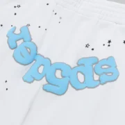 Close-up of Sp5der OG Logo Sweatshorts in white featuring blue Sp5der branding and black star print pattern details.