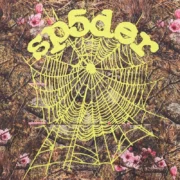 Close-up view of the Sp5der OG Web Real Tree hoodie featuring iconic yellow web and puff print text on brown camo