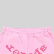 Close-up view of the Sp5der OG Web Ombre sweatpants in pink, showcasing the graphic puff print detail on the front.