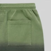 Close-up view of the Sp5der OG Web Ombre sweatpants in black showing the high-quality cotton fleece pocket detail.