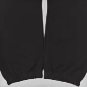 Close-up view of the premium black fabric and cuff detail on the Sp5der OG Web V2 Knicks Alternate sweatpants.