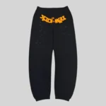 Front view of black Sp5der OG Web V2 Knicks Alternate Sweatpants featuring orange puff print and star details.