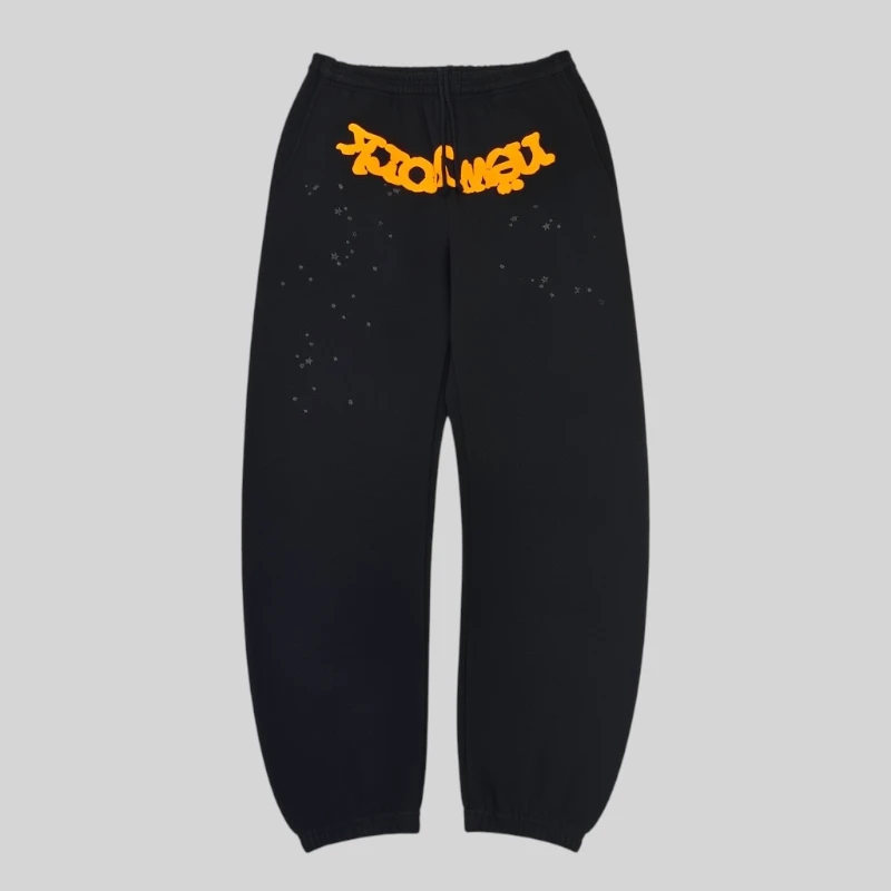 Front view of black Sp5der OG Web V2 Knicks Alternate Sweatpants featuring orange puff print and star details.
