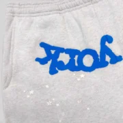 Close-up view of the Sp5der OG Web V2 Knicks Alternate sweatpants in grey featuring blue branding and small star details