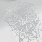 Close-up view of the Sp5der OG Web V2 Ombre Hoodie in Sport Grey, showcasing the signature puff print web graphic.