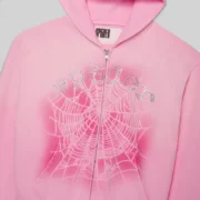 Light pink Sp5der OG Web V2 Spray zip-up hoodie featuring detailed rhinestone lettering and web graphic on the front.