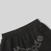 A close-up view of the black elastic waistband on the Sp5der OG Web V2 Sweatshorts showing fabric texture and branding.