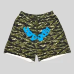 Sp5der OG Web V2 Tiger Camo Sweatshorts featuring a bold green camo pattern and signature blue graphic branding front view.