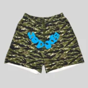 Sp5der OG Web V2 Tiger Camo Sweatshorts featuring a bold green camo pattern and signature blue graphic branding front view.