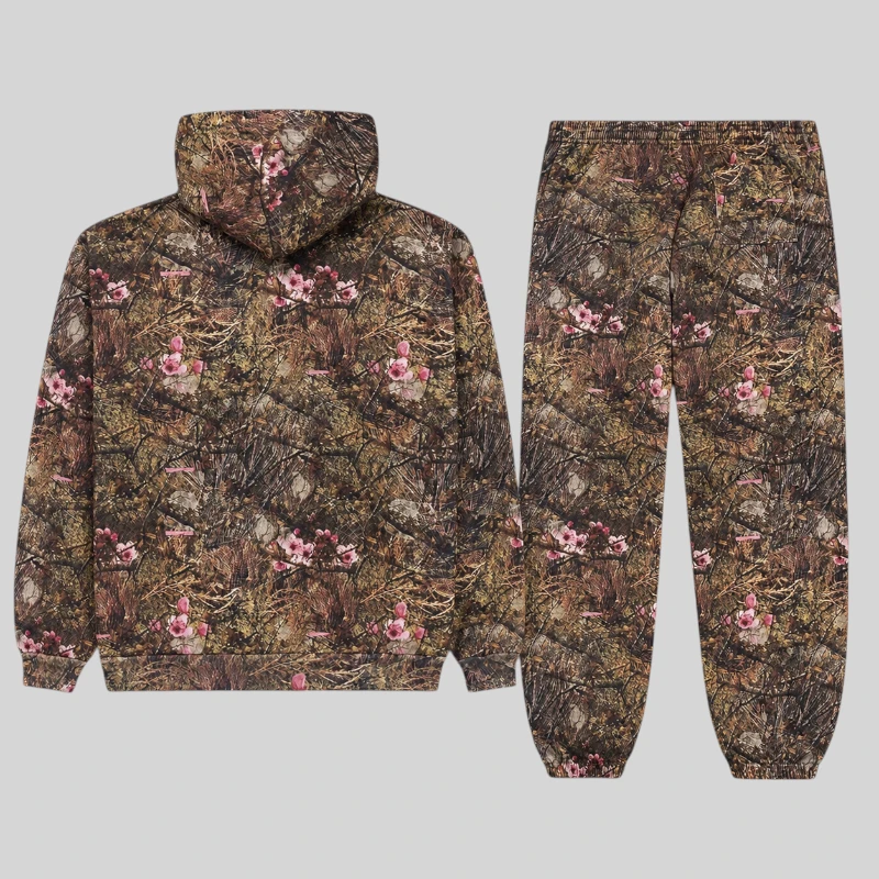 Back view of the Sp5der OG Web Real Tree Tracksuit featuring brown camouflage fleece and vibrant pink floral accents.