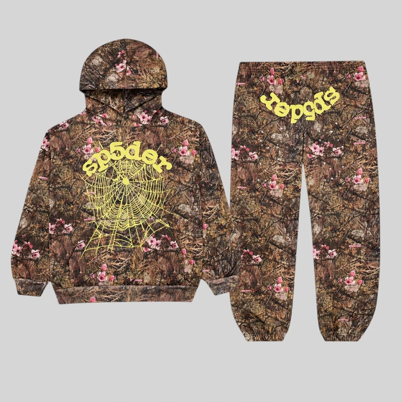 Sp5der OG Web Tracksuit in Real Tree camo featuring a brown fleece base, pink floral accents, and yellow branding.
