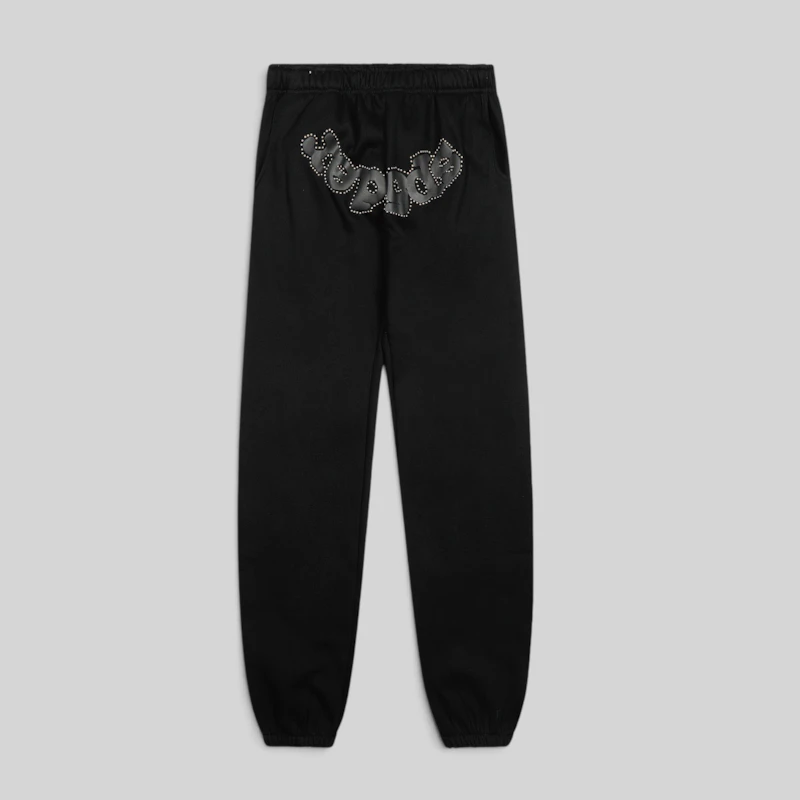 Front view of black Sp5der OG Web Studded Sweatpants featuring premium 13oz cotton fleece and detailed graphic prints.
