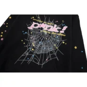 Close-up of the Sp5der P*NK Black Hoodie featuring the iconic pink text logo, spider web graphic, and colorful stars.