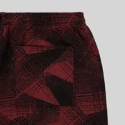 Close-up view of the Sp5der Plaid Splatt sweatpants in black featuring a premium cotton fleece textured pattern.
