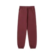 The back view of the brown Sp5der P*nk sweatpants showing the loose fit design and elasticated cuffs and waistband.