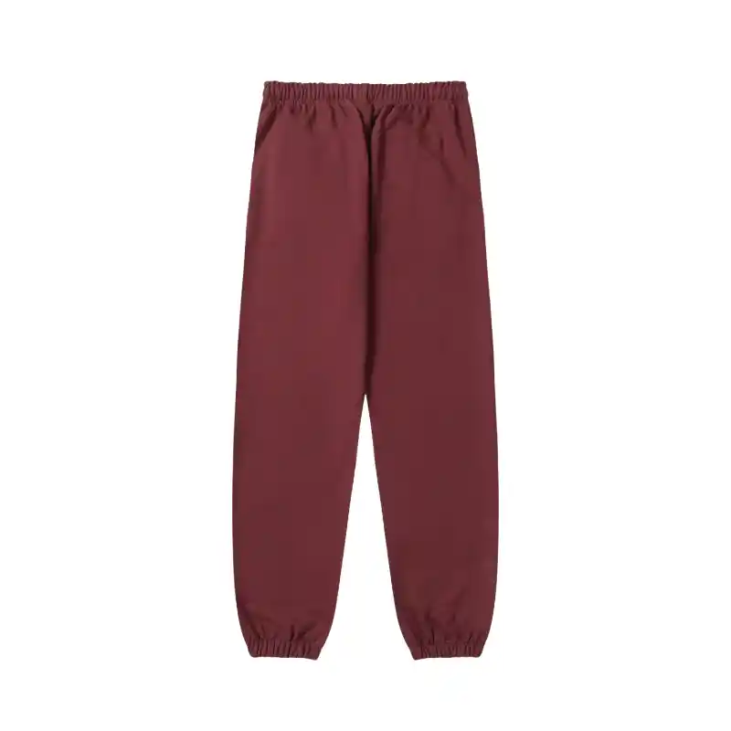 The back view of the brown Sp5der P*nk sweatpants showing the loose fit design and elasticated cuffs and waistband.