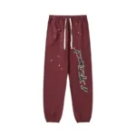 Front view of the Sp5der P*nk sweatpants in brown featuring a distressed print and a comfortable elasticated waistband.