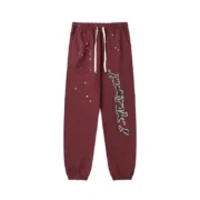 Front view of the Sp5der P*nk sweatpants in brown featuring a distressed print and a comfortable elasticated waistband.